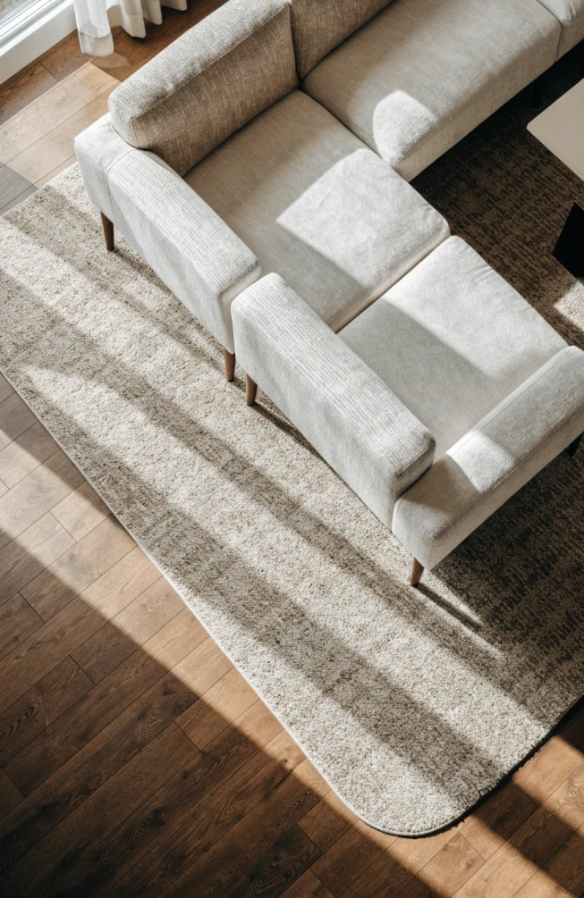 Size the rug to reach the sofa's front legs