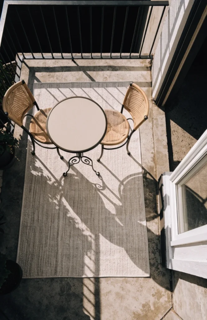 Anchor the space with one rug instead of furniture placement alone