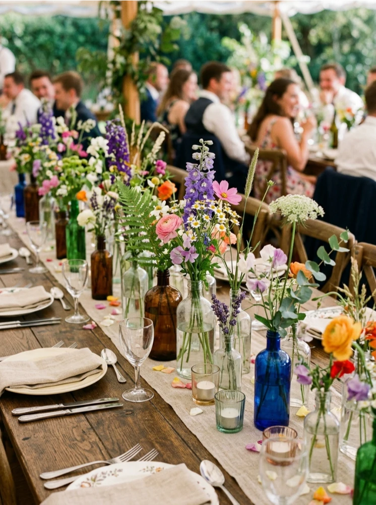Wildflowers scattered in vintage bottles