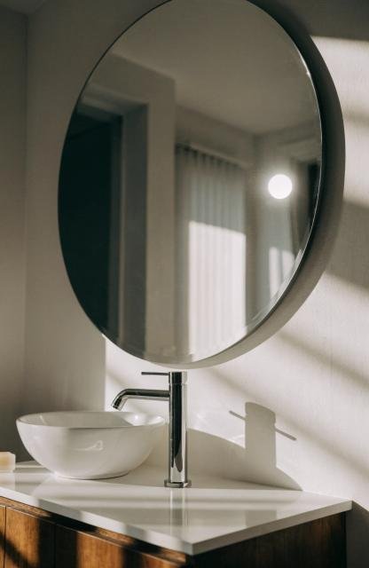 close-up-of-a-large-oversized-round-mirror-hung