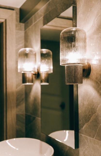 close-up-of-matching-wall-sconces-mounted-on-eithe.