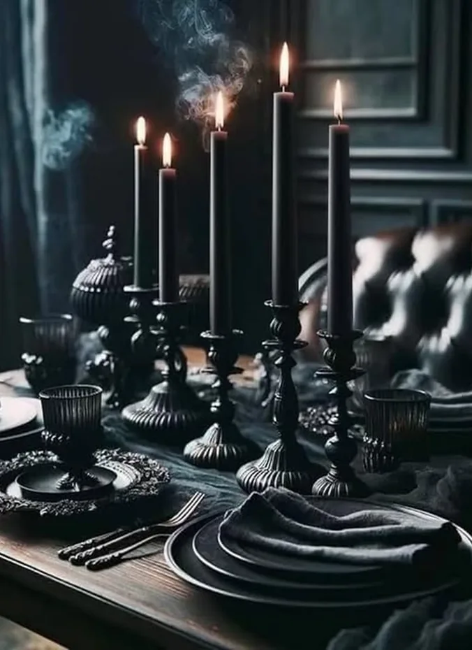 Cluster of black pillar candles in different heights on a dark tray