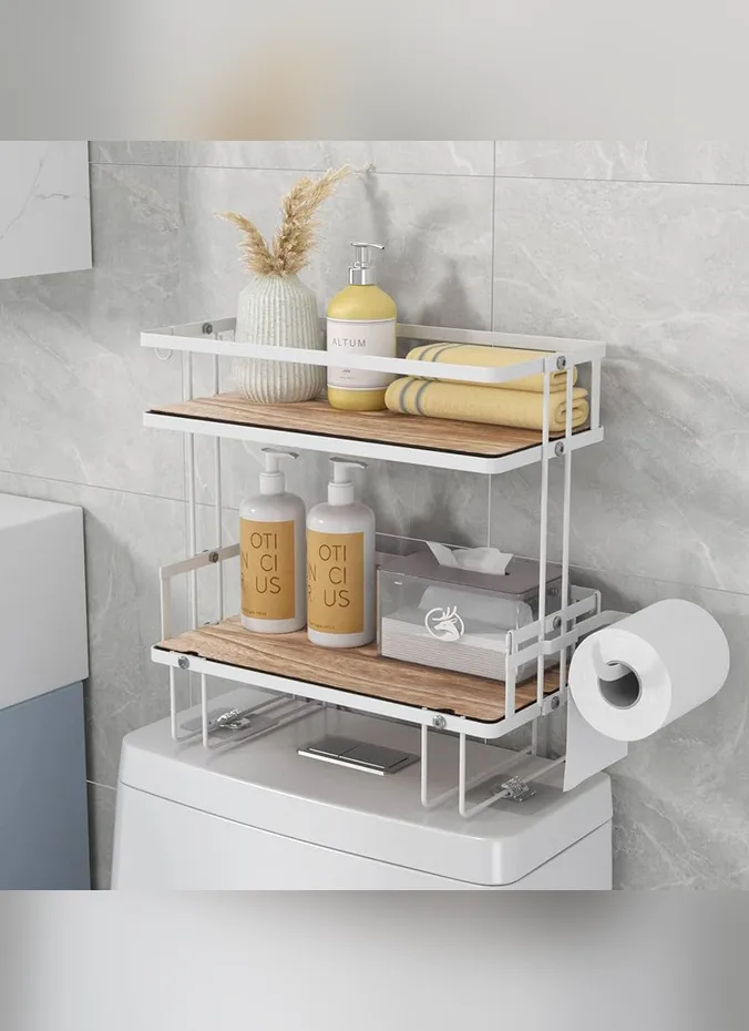 Three tier metal tray on a toilet tank holding towels and a small plant