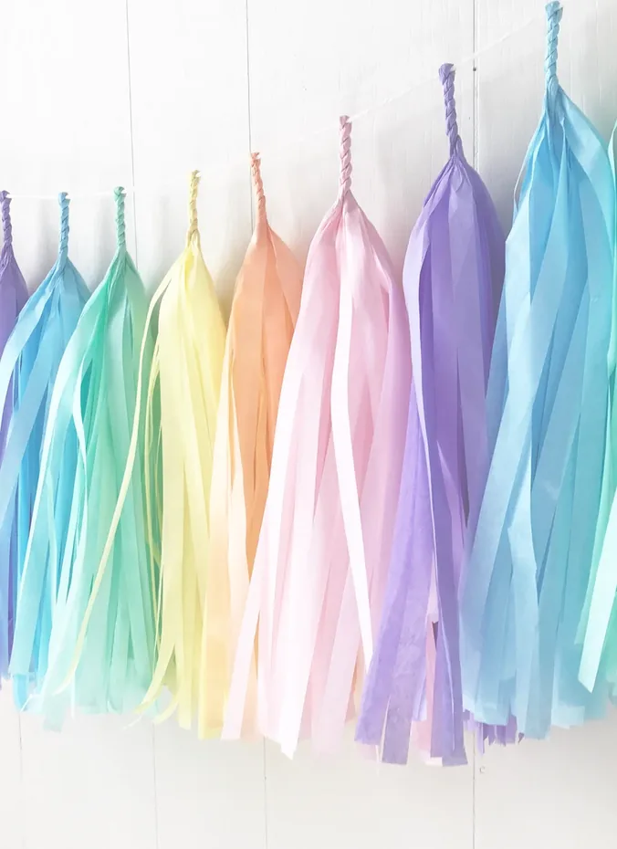 Rows of colorful tissue paper tassels hanging as a party backdrop