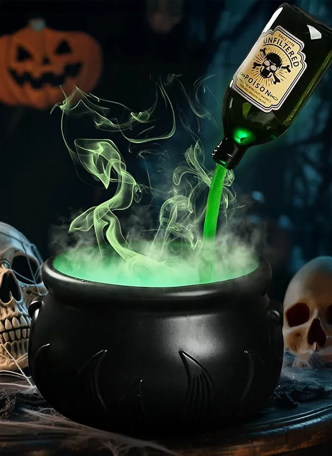 Small black cauldron with fog spilling over the rim on a table
