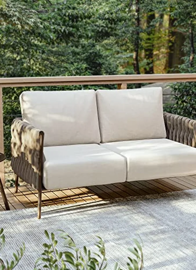 Outdoor sofa with washable cushions on a summer back porch