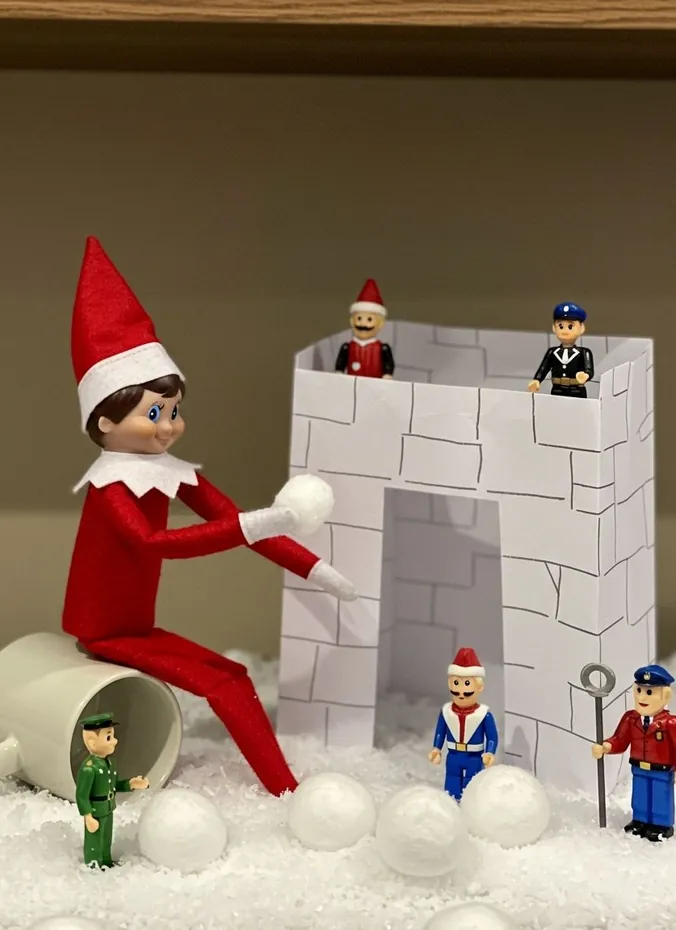 Elf on the shelf in a snowball fight with stuffed animals and cotton balls