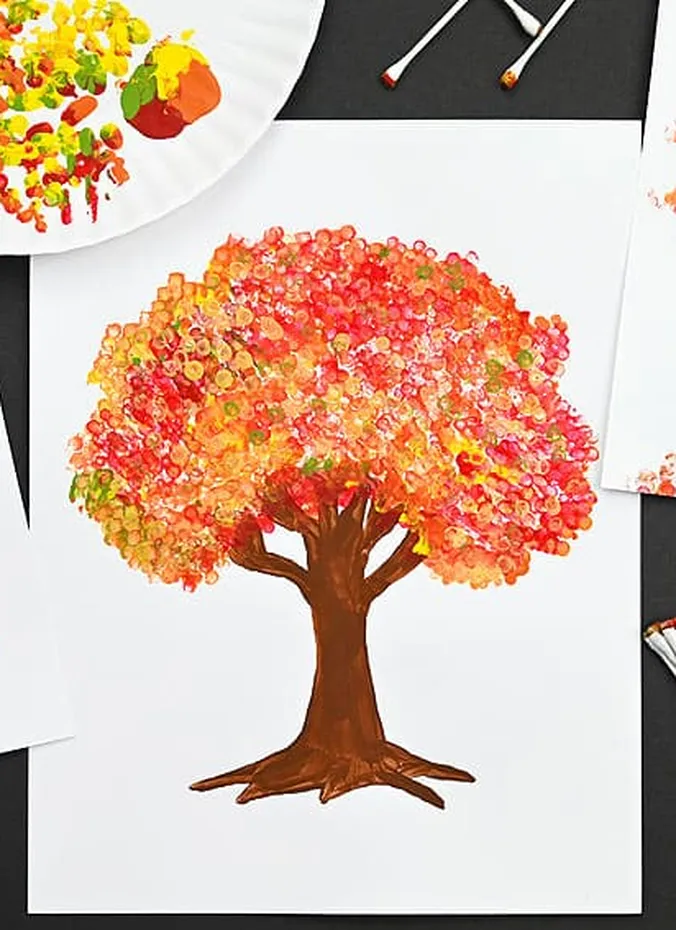 Fall tree painting made with cotton swab dots in red orange and yellow
