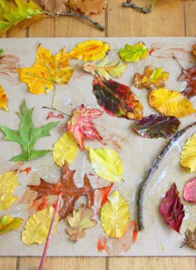 Nature collage of pressed fall leaves on sticky contact paper