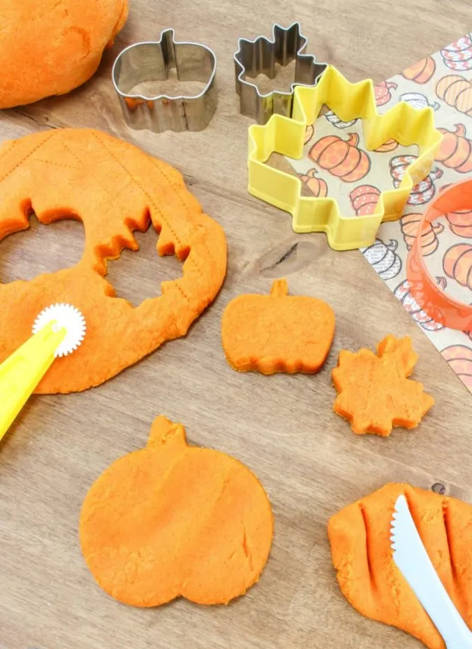 Orange pumpkin spice playdough with pumpkin and leaf cookie cutters