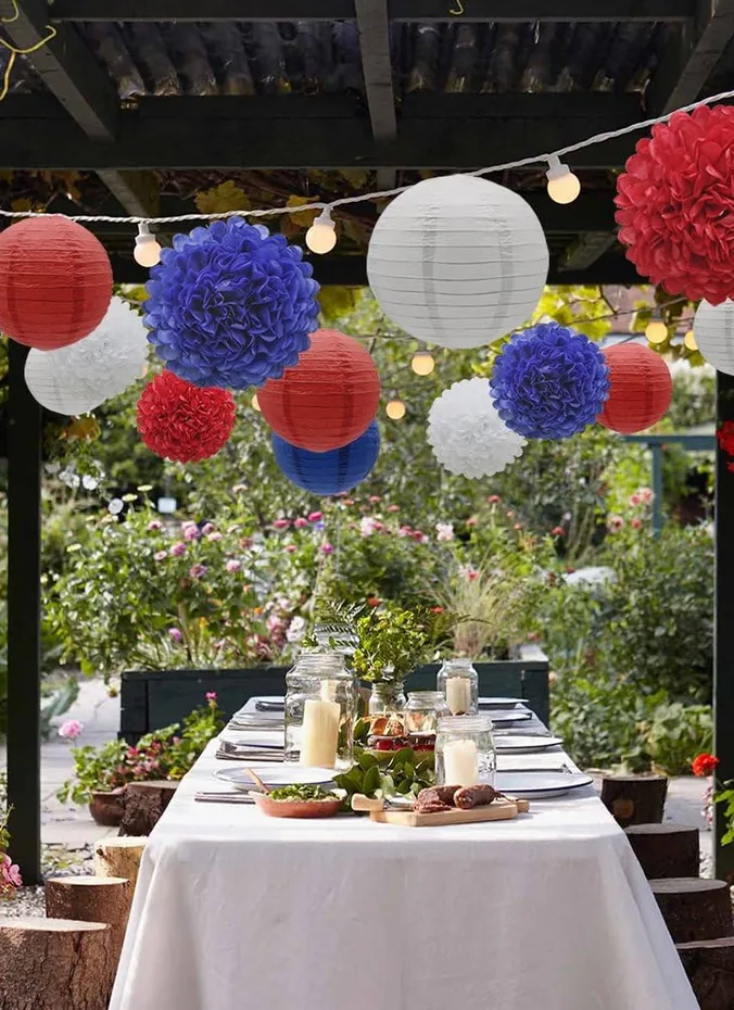 Red white and blue paper lanterns hanging above a patio party