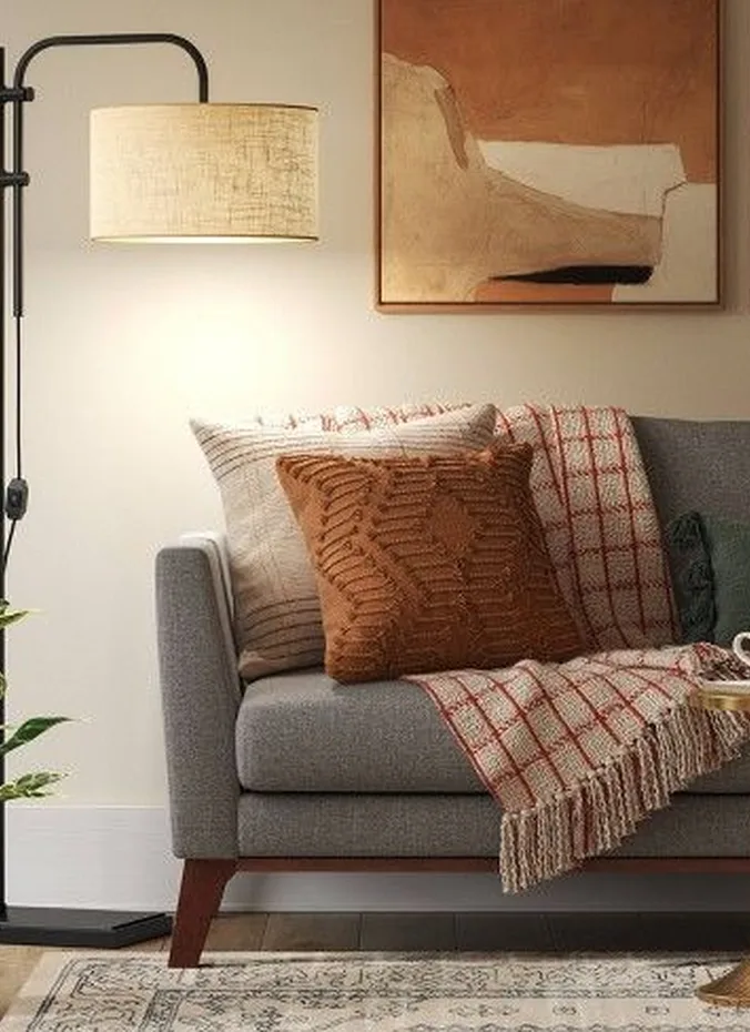 Floor lamp beside an armchair giving warm light in an apartment living room