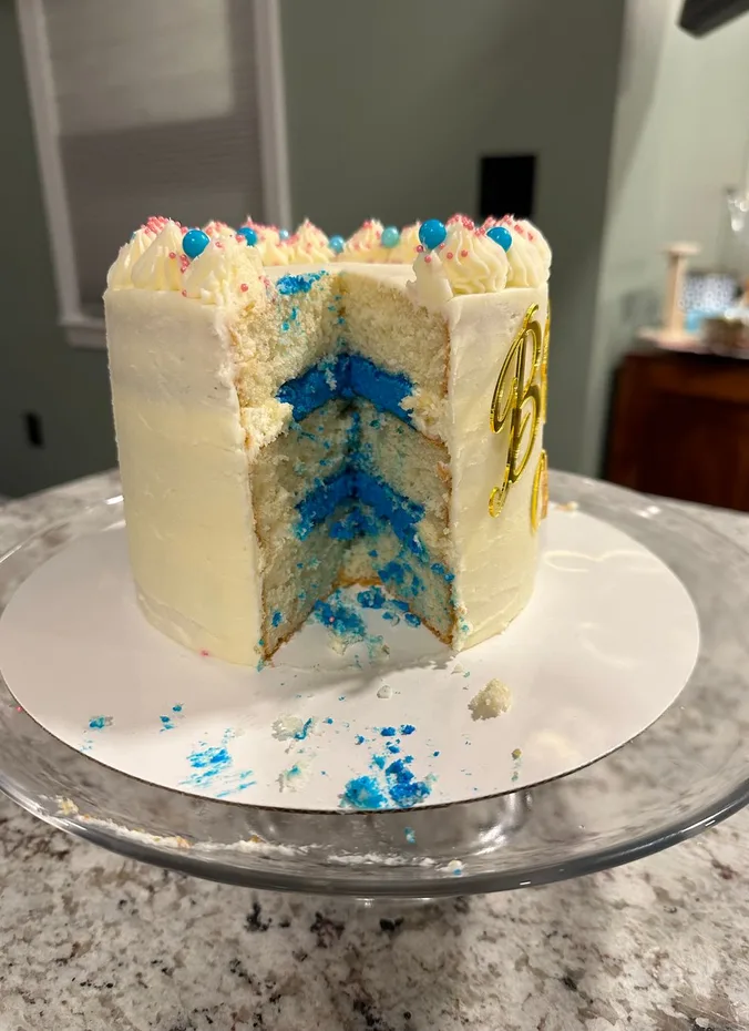Gender reveal cake ready to be cut at a party