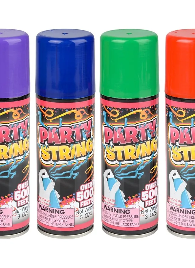 Guests spraying pink silly string at an outdoor reveal party