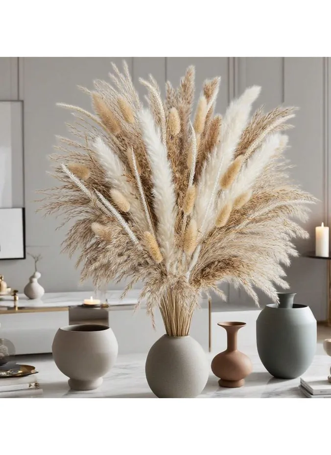 Dried stems in a vase above kitchen cabinets