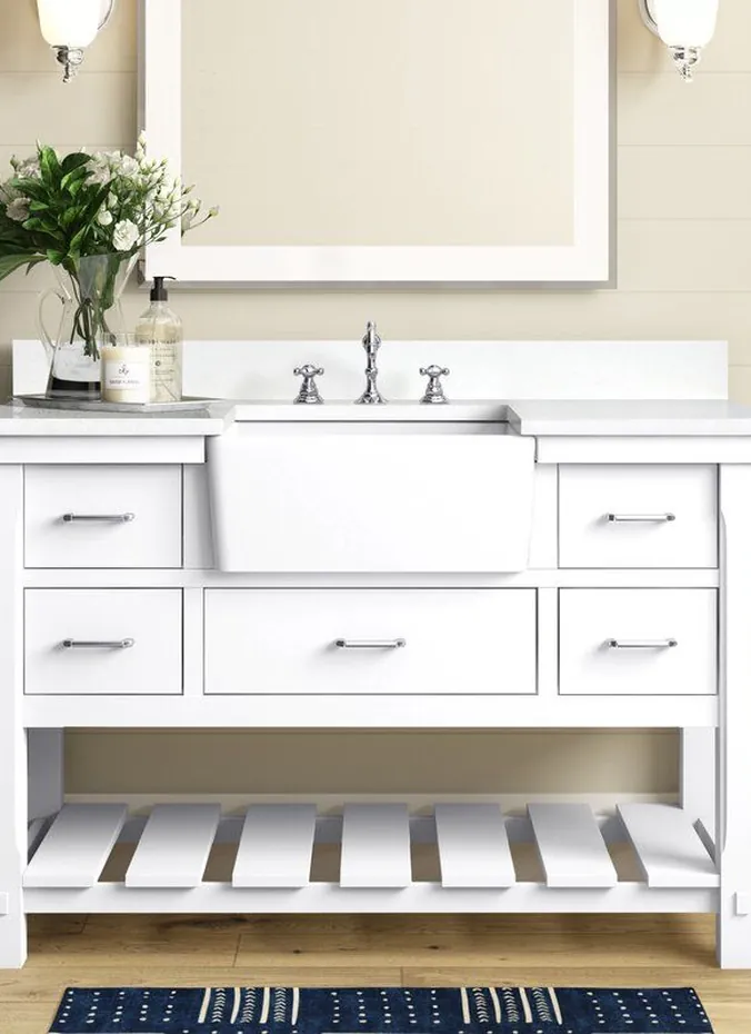 White apron front farmhouse sink on a bathroom vanity