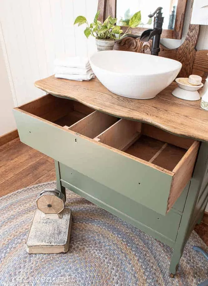 Repurposed wood dresser used as a bathroom vanity with vessel sink