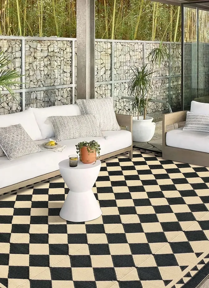 Black and white checkered outdoor rug on a patio