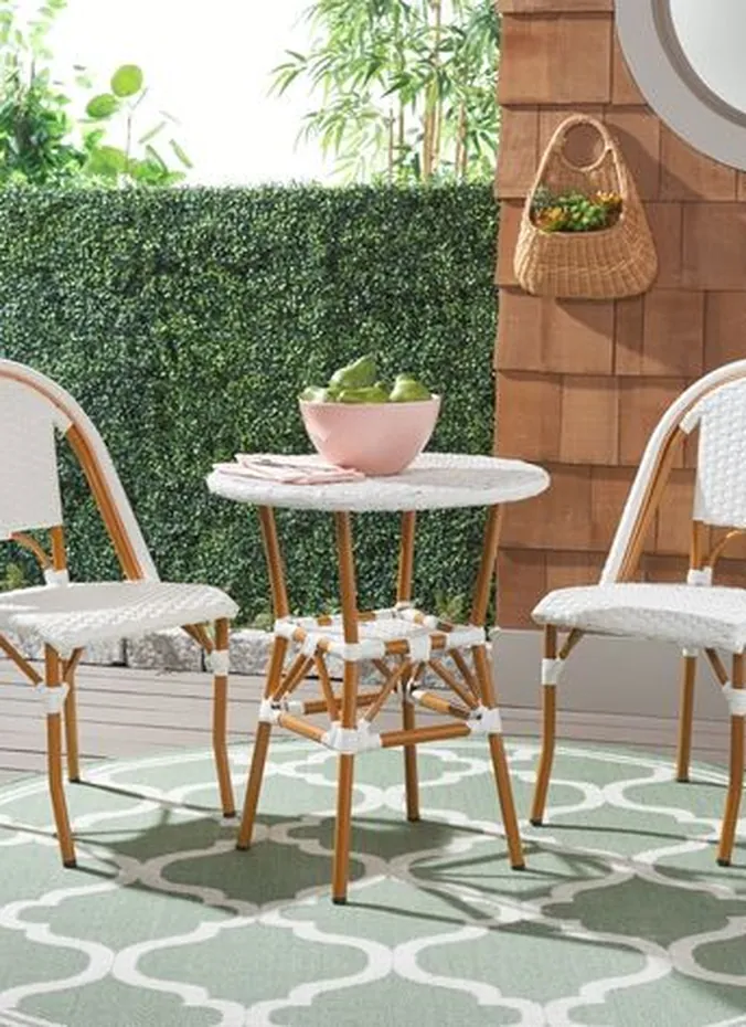 Round outdoor rug under a small bistro table on a patio