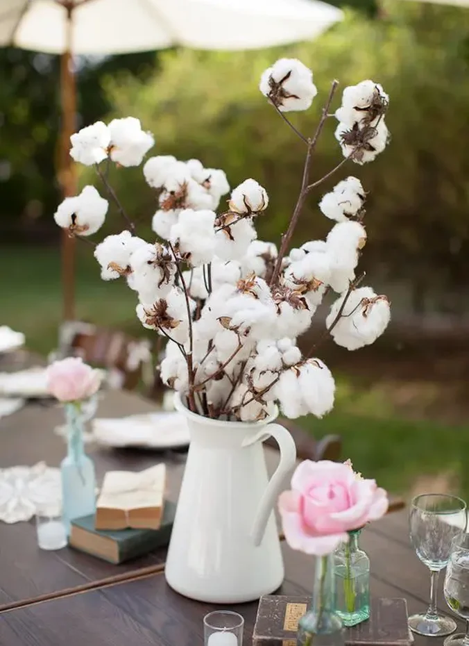 Cotton stems with lace in a rustic wedding centerpiece