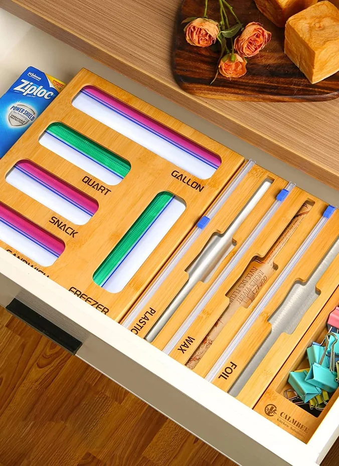 Divided caddy holding plastic wrap foil and parchment above the fridge