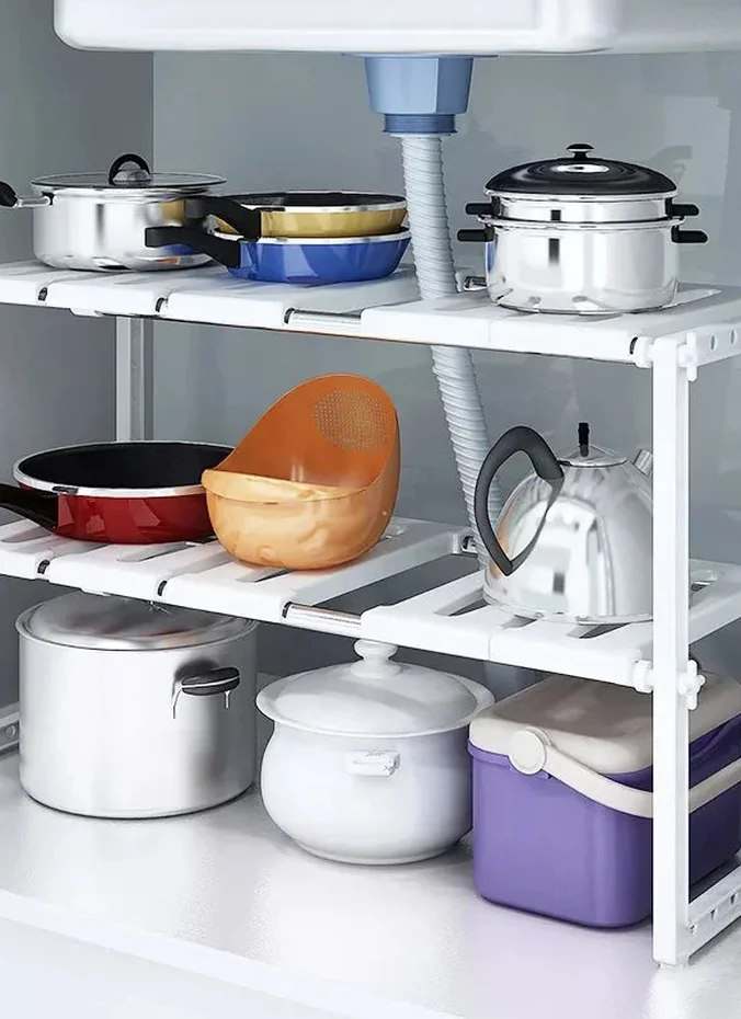 Metal riser shelf creating two levels of storage above refrigerator