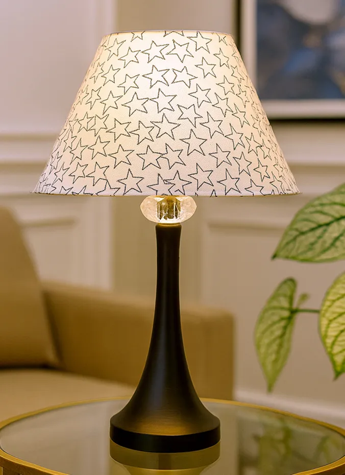 Table lamp with a subtle star patterned shade