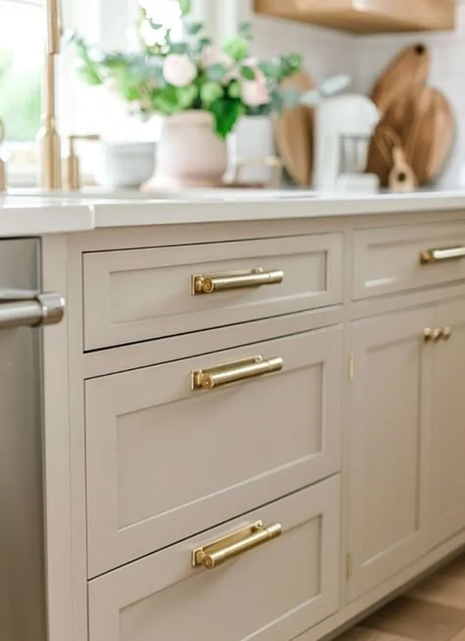 Brushed brass cabinet hardware on kitchen cabinets close up