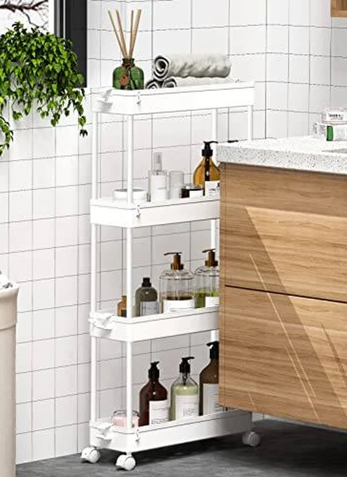 Slim rolling cart with towels beside a small vanity