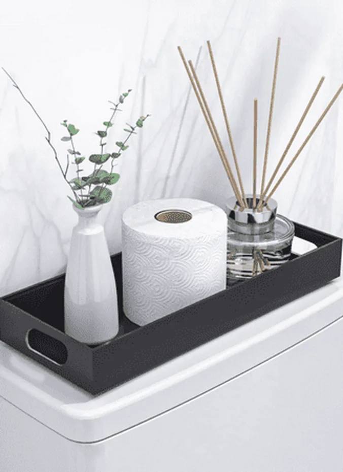 Small wooden tray with candle and bud vase styled on a toilet tank lid