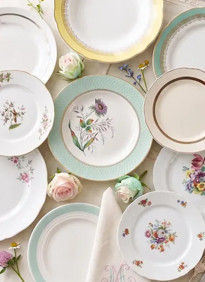 Mismatched vintage china plates set for a Thanksgiving dinner