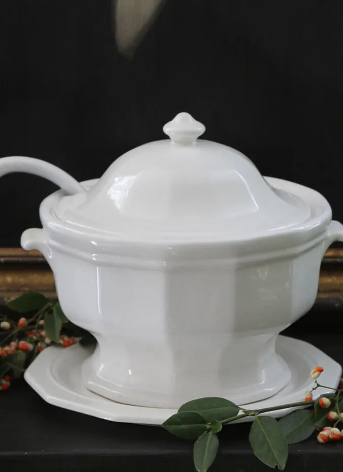 White ironstone tureen filled with apples as a table centerpiece
