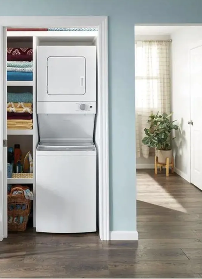 Front load washer and dryer stacked as a pair with a stacking kit