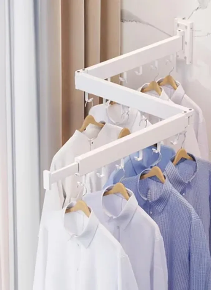 Wall mounted folding drying rack in a laundry area