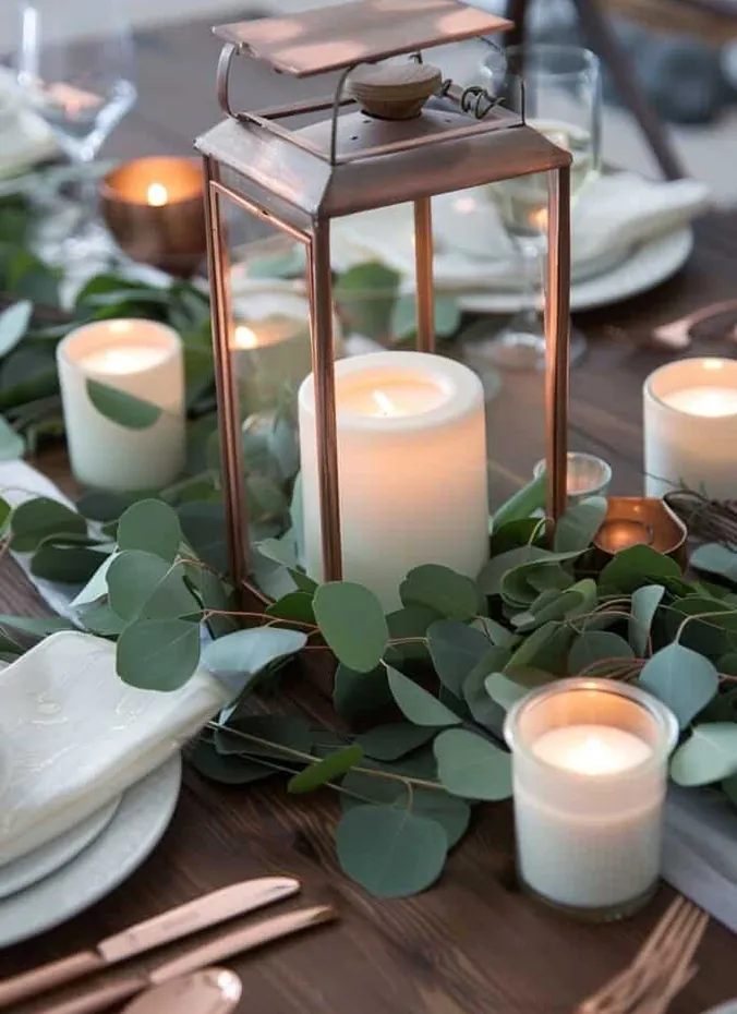Eucalyptus sprigs styled around candles on a wedding table